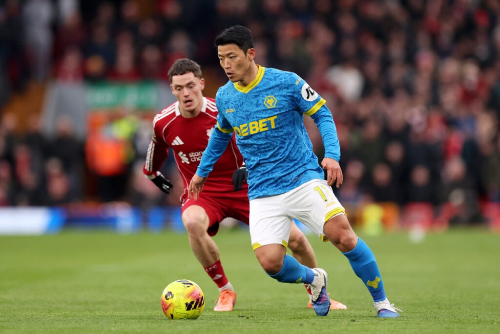 Hwang Hee-Chan of Wolverhampton Wanderers controls the ball whilst under pressure from Florian Wirtz