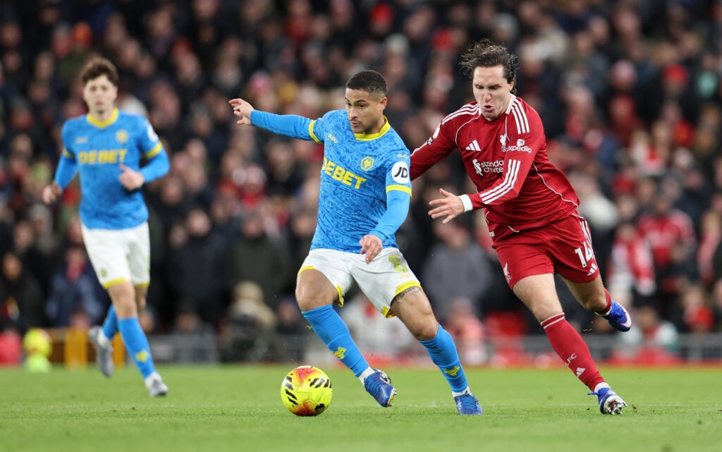 Joao Gomes dribbling with the ball vs Liverpool as Chiesa chases