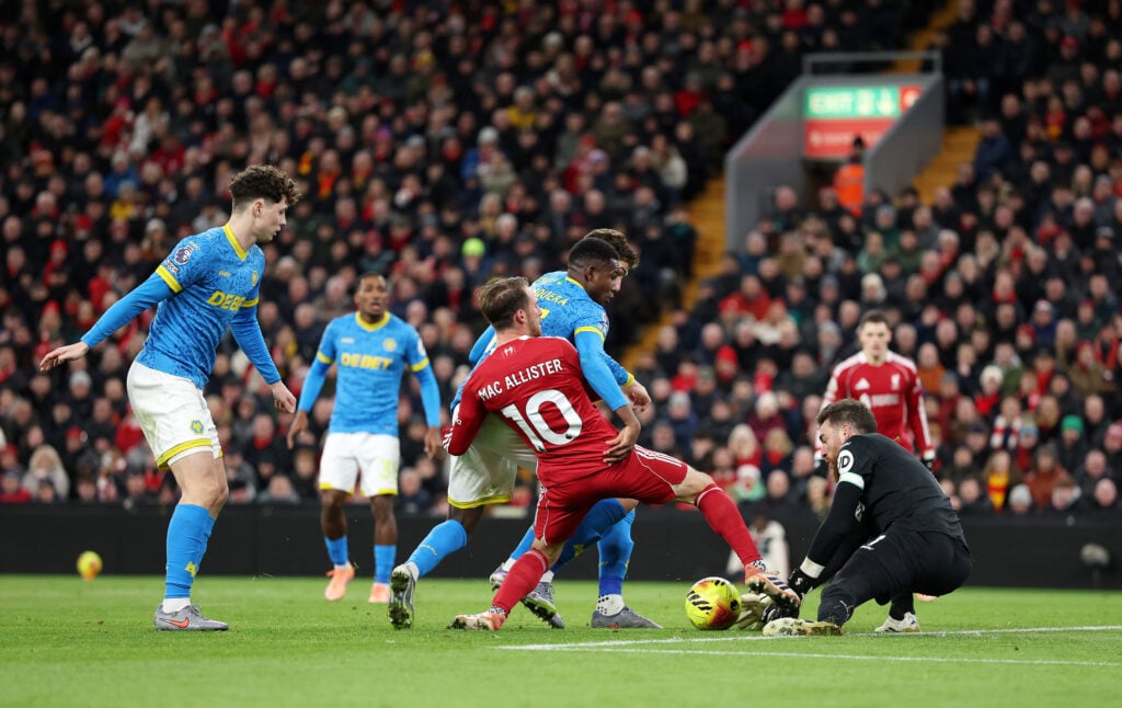 Alexis Mac Allister of Liverpool challenges Yerson Mosquera and Jose Sa of Wolverhampton Wanderers during the Premier League match between Liverpool and Wolverhampton Wanderers