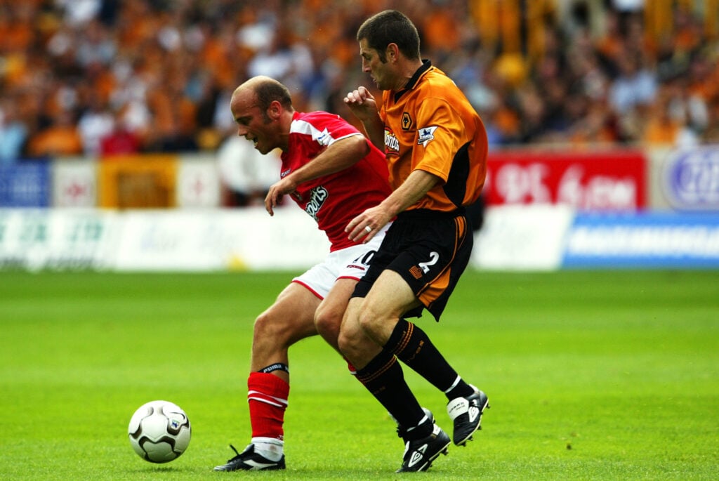 Claus Jenson of Charlton Athletic shields the ball from Denis Irwin of Wolverhampton Wanderers
