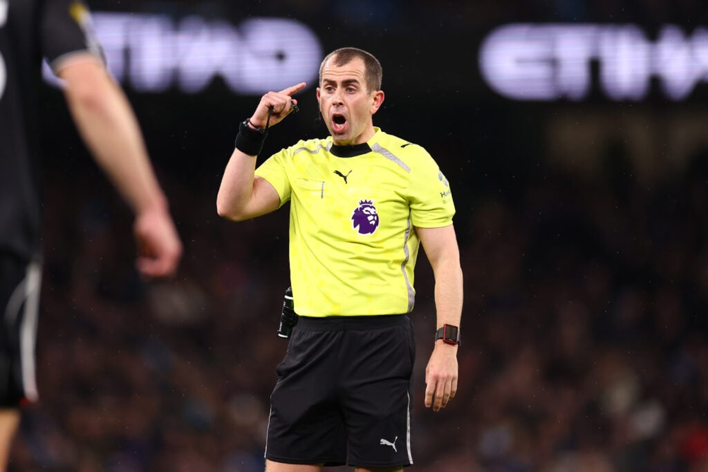 Peter Bankes working as a referee in the Premier League at the Etihad stadium