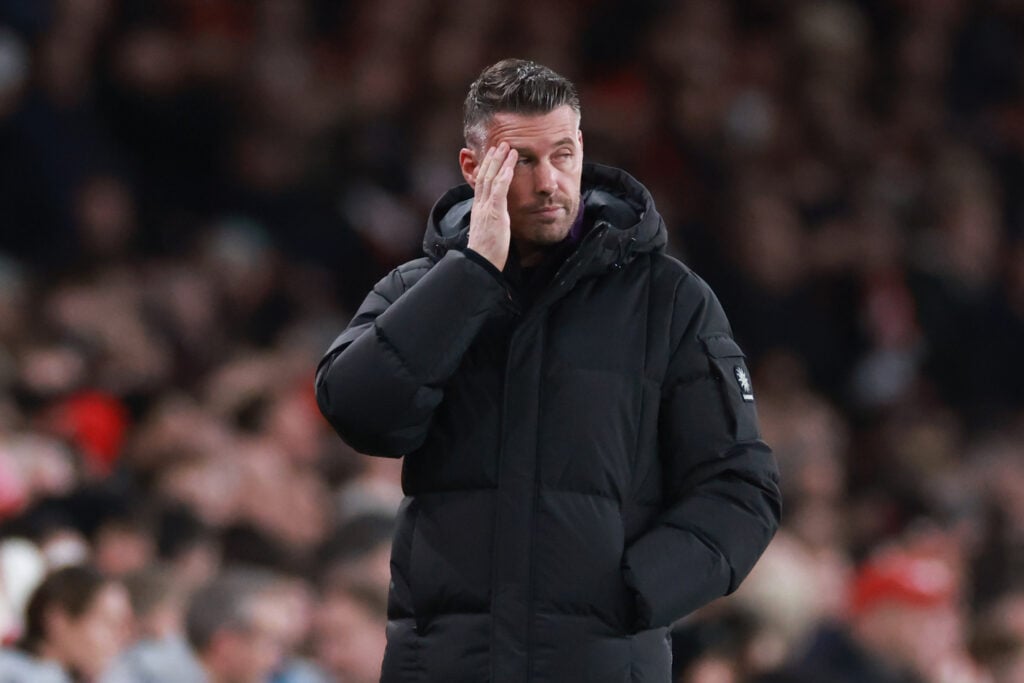 Rob Edwards with hand to face on touchline