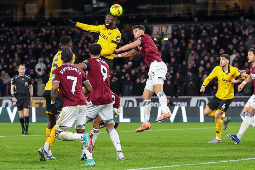 Tolu Arokodare of Wolverhampton Wanderers and Max Kilman of West Ham United battle in the air to head the ball during the Premier League match between Wolverhampton Wanderers and West Ham United at Molineux
