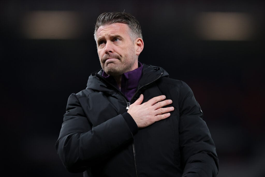 Rob Edwards, head coach of Wolverhampton Wanderers, acknowledges the traveling support after the Premier League match between Manchester United and Wolverhampton Wanderers