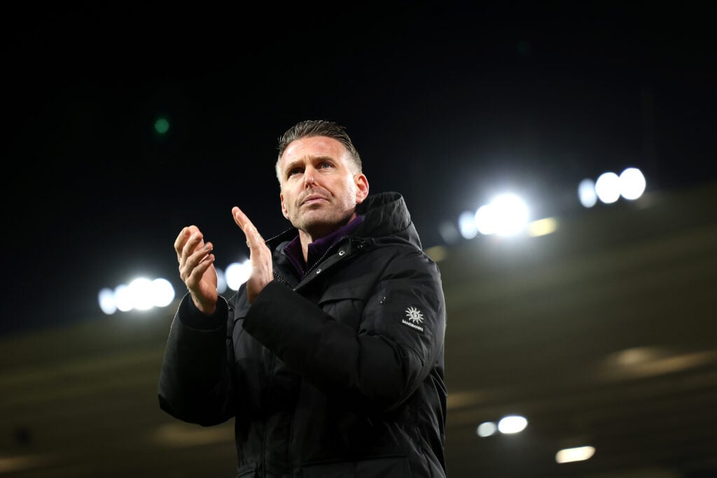 Rob Edwards claps fans.