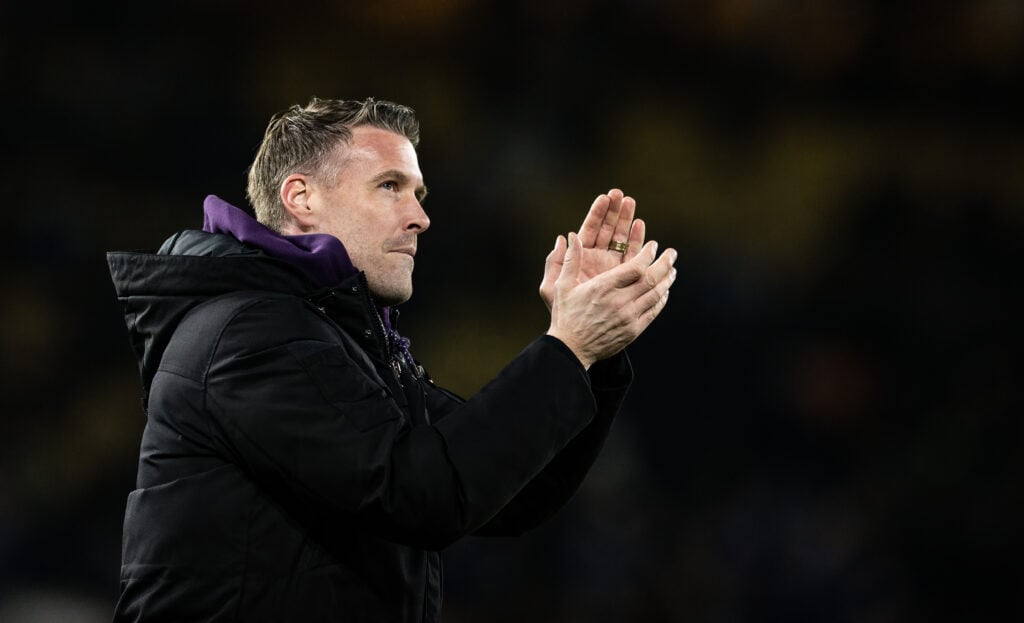 Rob Edwards claps the fans.