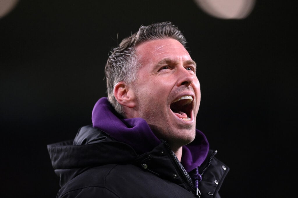 Rob Edwards cheers while managing Wolves.