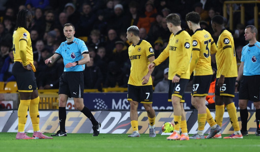 Wolves players surround the referee.