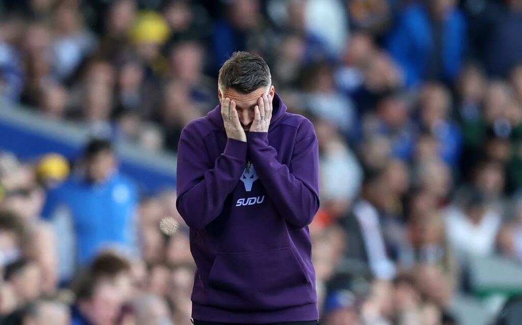 Rob Edwards puts his head in his hands.