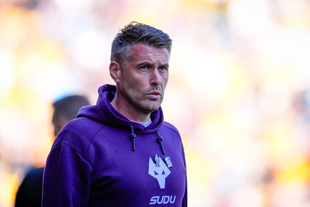 Rob Edwards looks on.