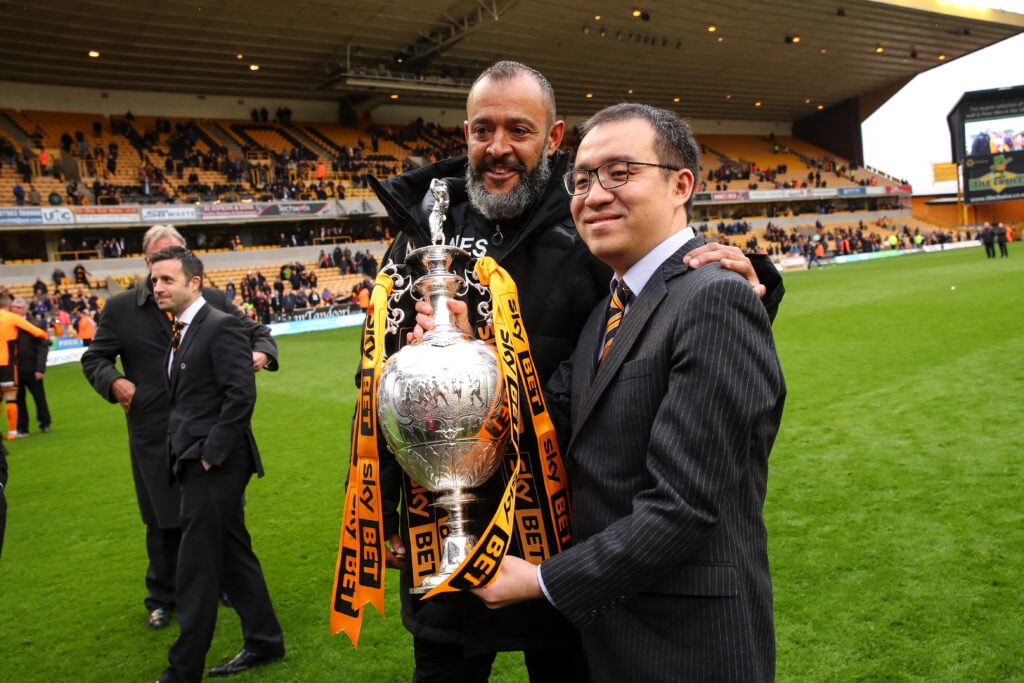 Nuno Espirito Santo and Jeff Shi hold the Championship trophy.