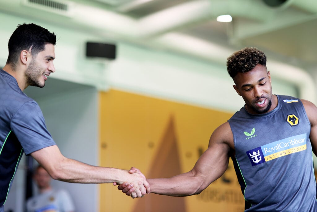 Adama Traore and Raul Jimenez shake hands.